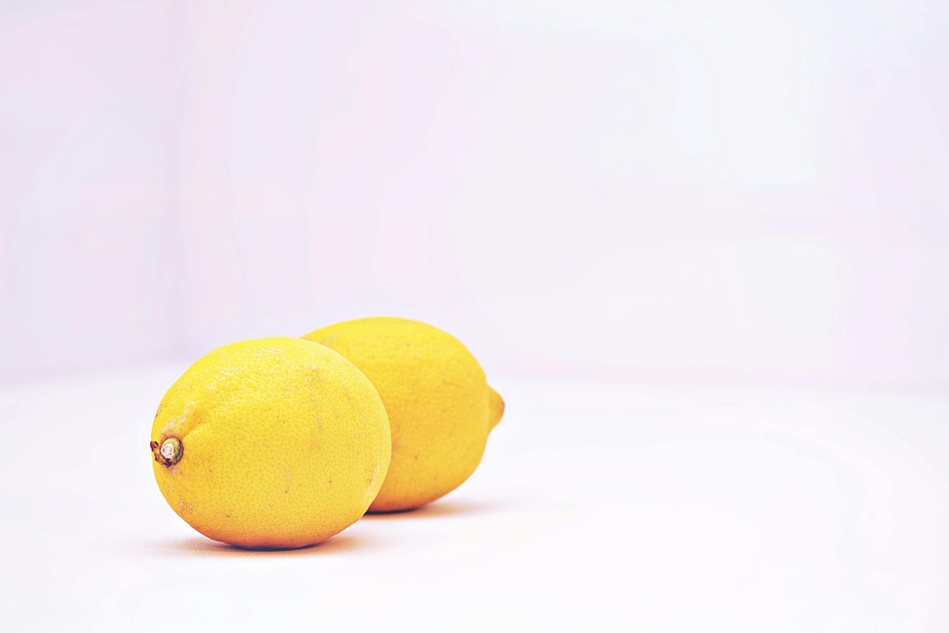 Two bright lemons against a white background, symbolizing distinct needs and desires in a relationship.