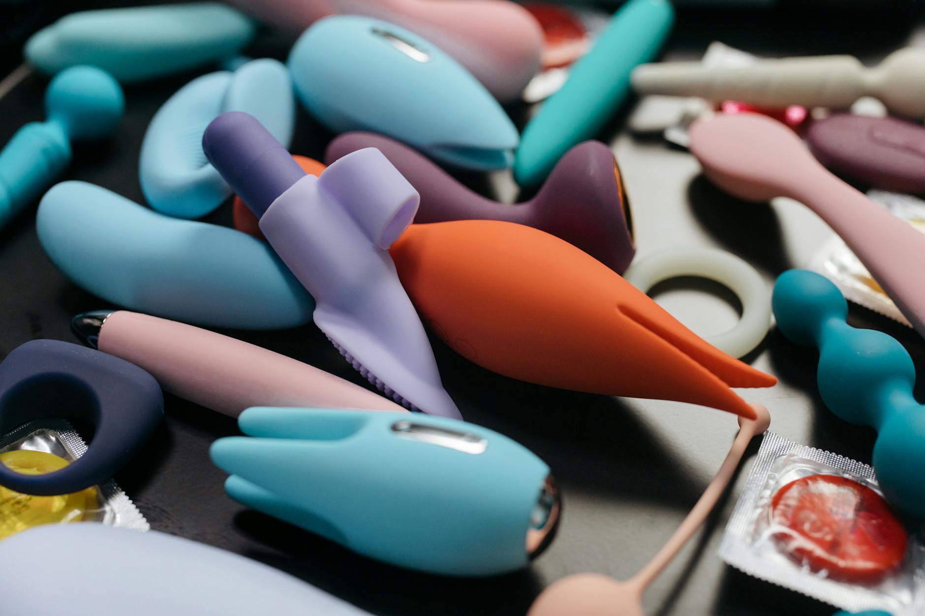 An array of vibrant adult toys including vibrators and suction toys displayed close-up