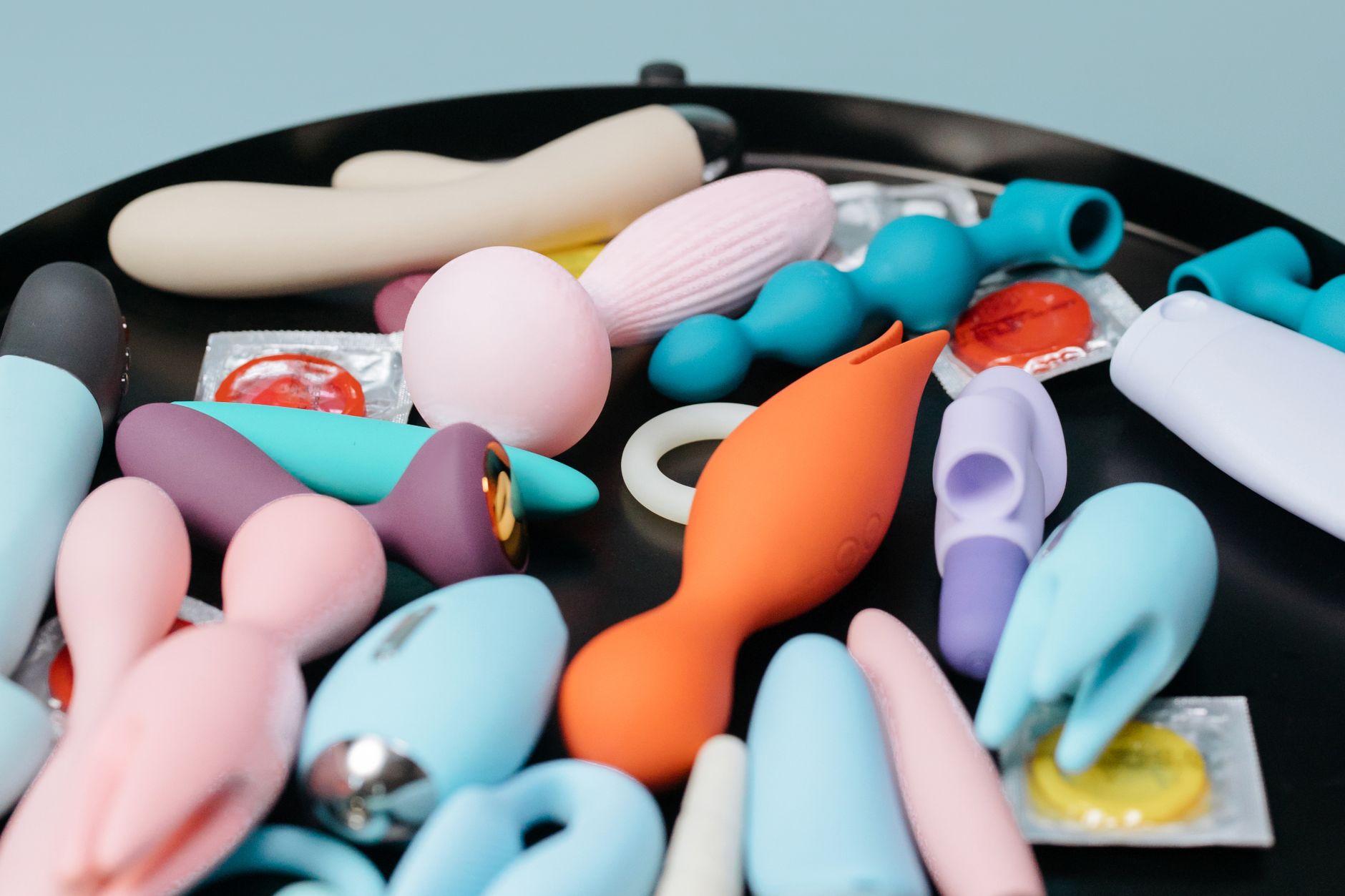 A blue silicone clitoral vibrator held in hand, symbolizing personal pleasure and reclaiming sensation after relationship challenges