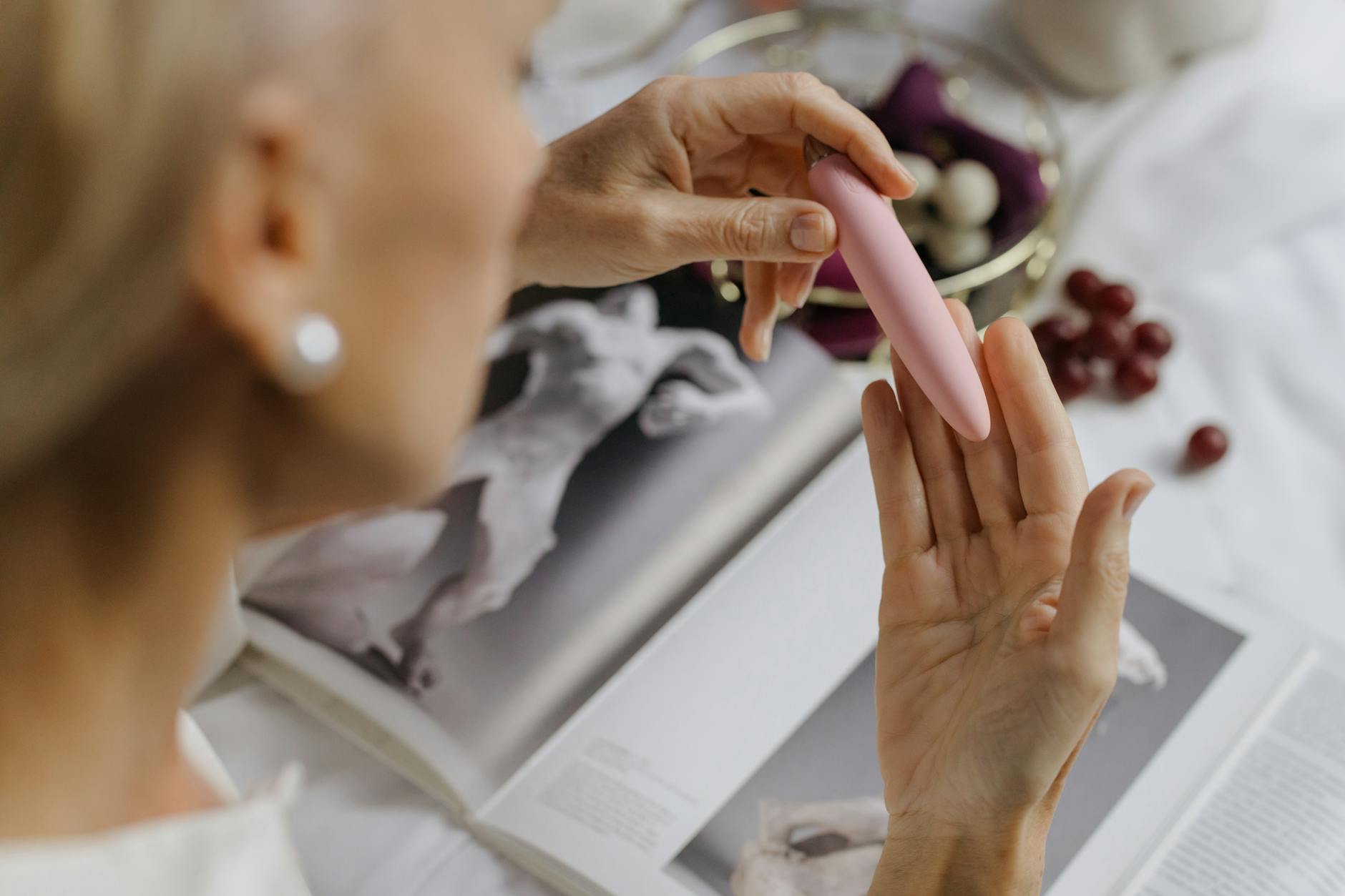 Woman holding two colorful vibrators, representing intimate pleasure and connection options